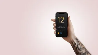 Tattooed Arm holding iPhone 12